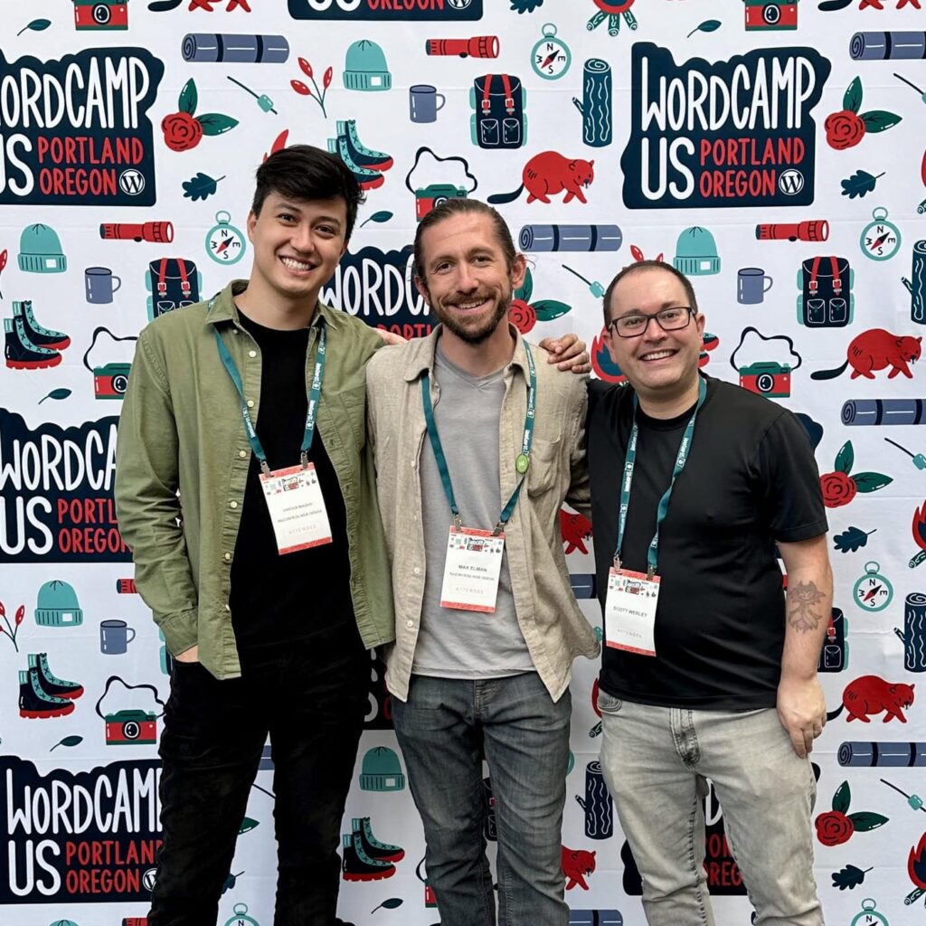 The Razorfrog Team (Vinícius, Max and Scott) standing in front of the WordCamp US 2024 backdrop. It is patterned with the conference logo and cartoon illustrations of camping gear and nature-theme elements.